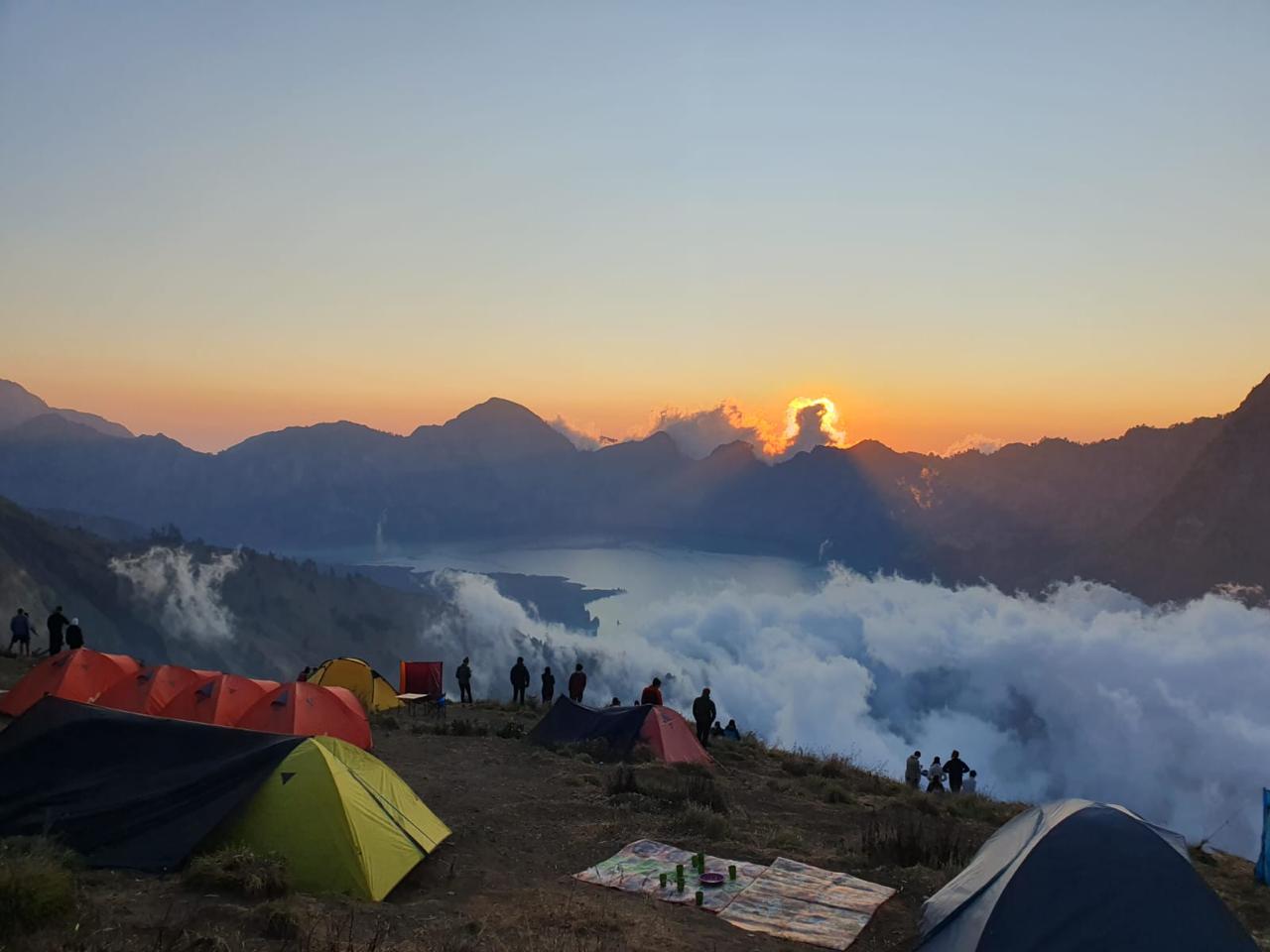 Beautiful sunrise view during Rinjani trekking from the crater rim campsite overlooking Segara Anak Lake, Mount Rinjani Lombok Indonesia