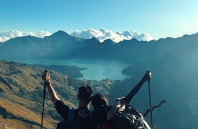 Trekkers enjoying panoramic view of Segara Anak Lake during Rinjani trekking adventure on Mount Rinjani Lombok Indonesia