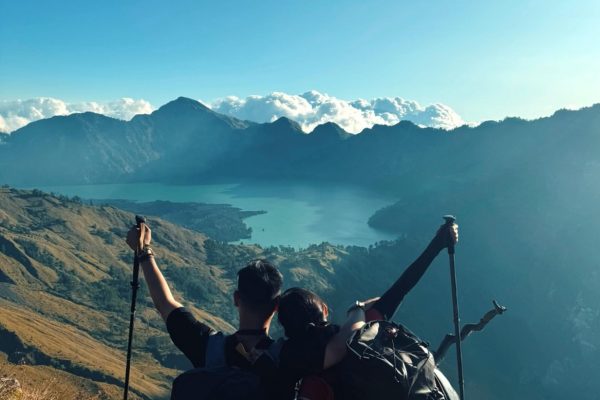 Trekkers enjoying panoramic view of Segara Anak Lake during Rinjani trekking adventure on Mount Rinjani Lombok Indonesia