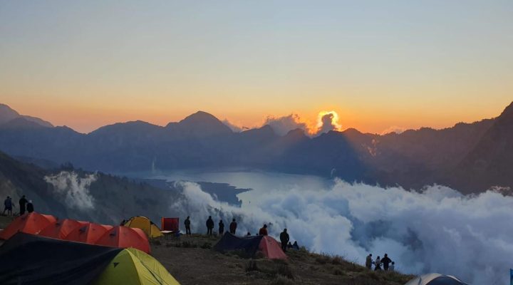 Beautiful sunrise view during Rinjani trekking from the crater rim campsite overlooking Segara Anak Lake, Mount Rinjani Lombok Indonesia
